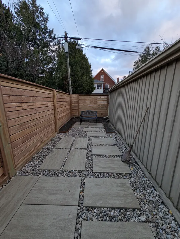 New horizontal fence along a stepping stone side path