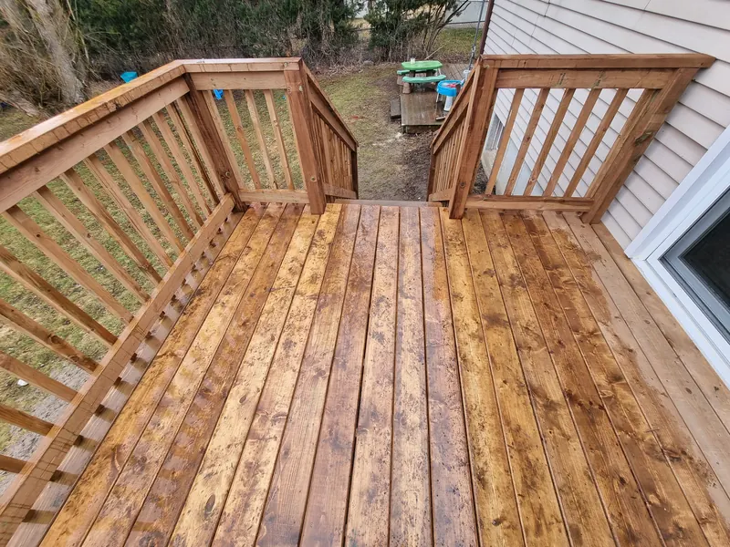 New pressure treated deck with wood railing and gate