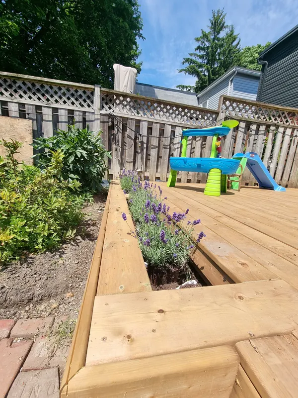 Deck with built-in planter cutout filled with lavender